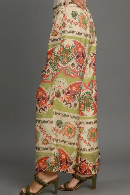 Plus size Umgee wide-leg border print pants in green mix, featuring a relaxed fit and stylish design.