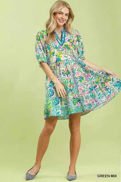 Green Umgee Mix botanical print puff sleeve tiered dress with floral pattern and ruffled sleeves, perfect for casual or semi-formal wear.