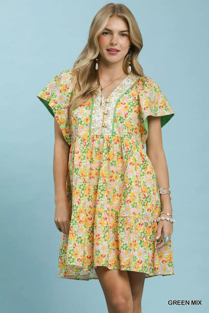 Green floral tiered mini dress by Umgee with side pockets, featuring a breezy, feminine design and lightweight fabric.