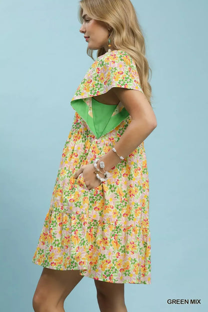 Green Umgee floral tiered mini dress with side pockets, featuring a mix of floral patterns and a relaxed fit.