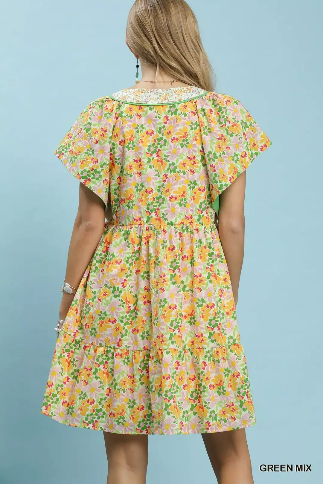 Green floral tiered mini dress by Umgee with side pockets, featuring a relaxed fit and feminine print.