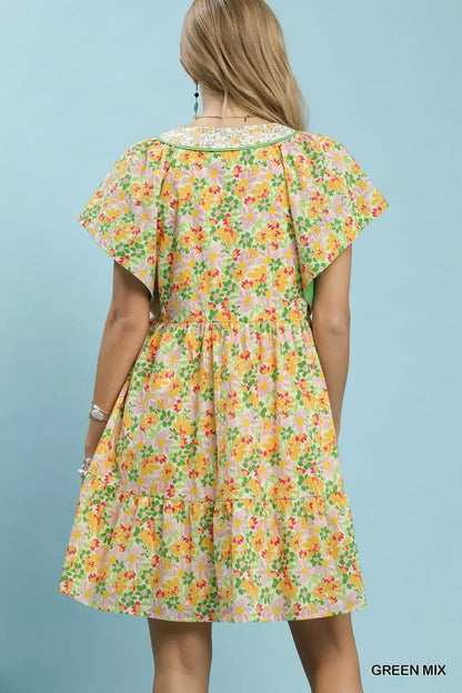 Green floral tiered mini dress by Umgee with side pockets, featuring a relaxed fit and feminine print.