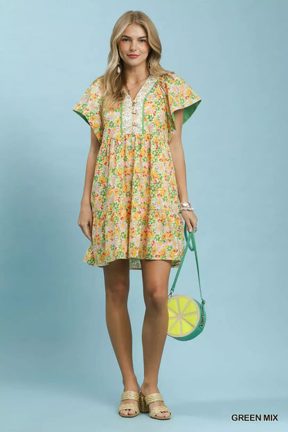 Green floral tiered mini dress by Umgee with side pockets, featuring a mixed floral pattern and casual, flowy style.