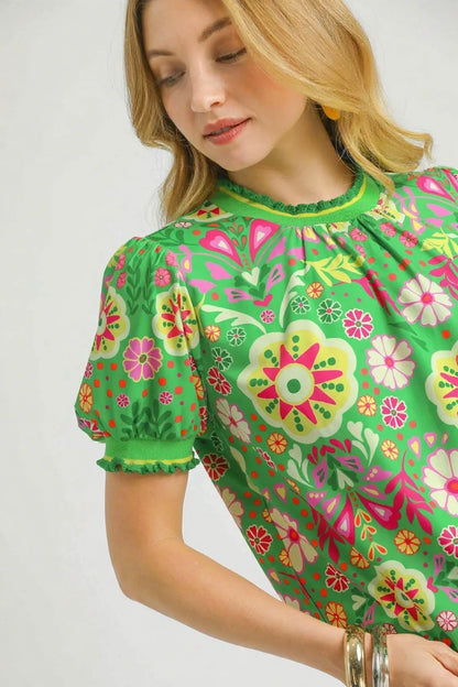 Green floral puff sleeve top by Umgee featuring retro style and a relaxed fit, shown on a white background.