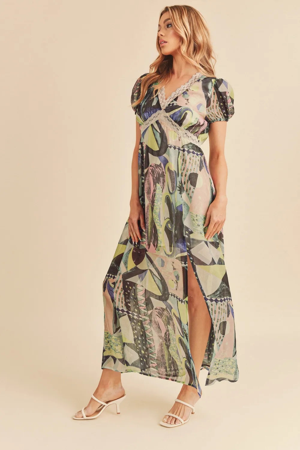 Green Aemi + Co lace detail slit geometric print short sleeve maxi dress by Trendsi, shown with its stylish design and flowy fabric.