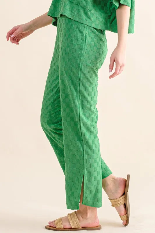 Green casual pants from Trendsi with a brushed texture and checkerboard pattern, featuring a relaxed fit and stylish design.