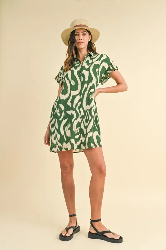 Green Annie Wear abstract printed frill sleeve shirt mini dress by Trendsi, showcasing a stylish design with ruffled sleeves.