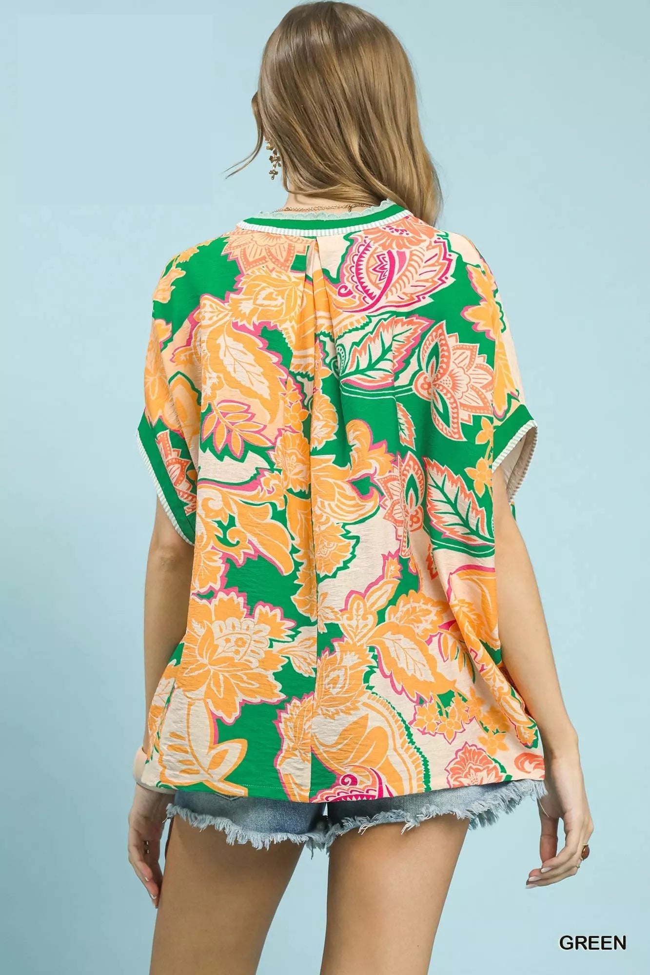 Green Umgee oversized top with abstract print, featuring a relaxed fit and stylish design, perfect for casual wear.