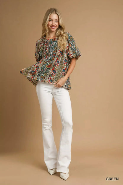 Green Umgee boho floral stripe puff sleeve blouse with relaxed fit and ruffled cuffs, styled with casual accessories.