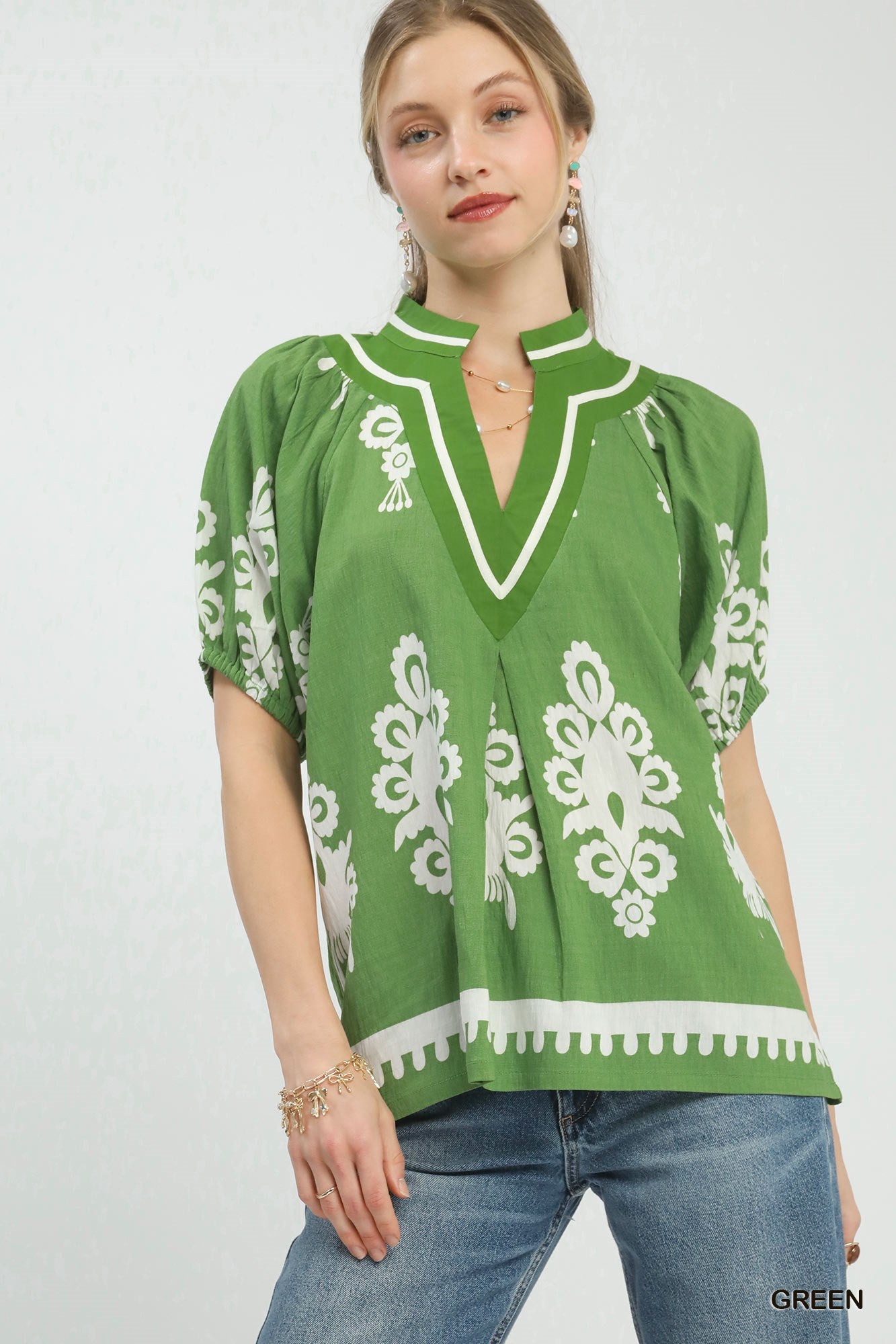 Green Umgee boho print split-neck short sleeve top featuring a relaxed fit and casual style.