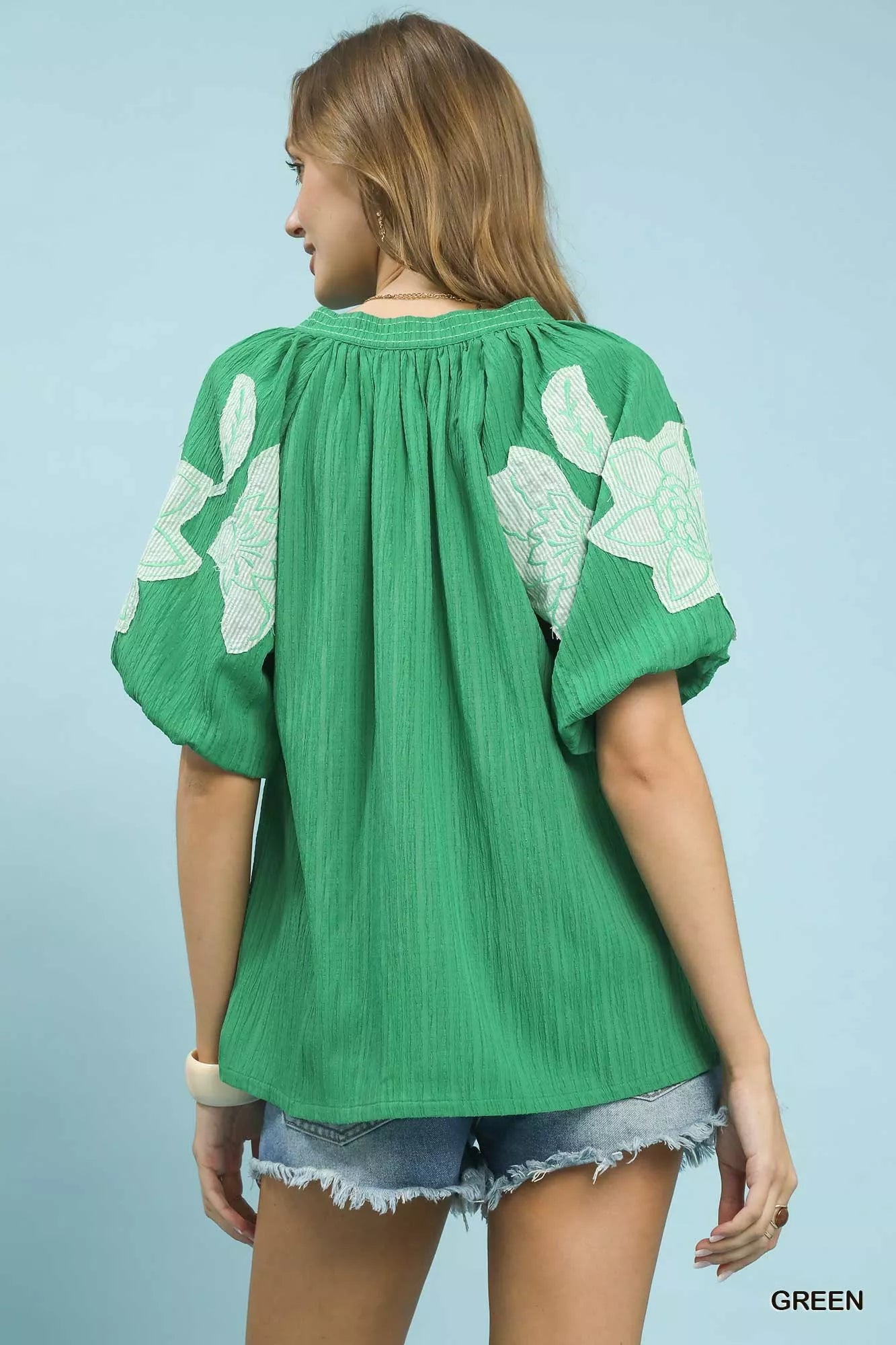 Green Umgee embroidered balloon sleeve blouse with notch neckline, stylish and feminine, featuring intricate embroidery details.