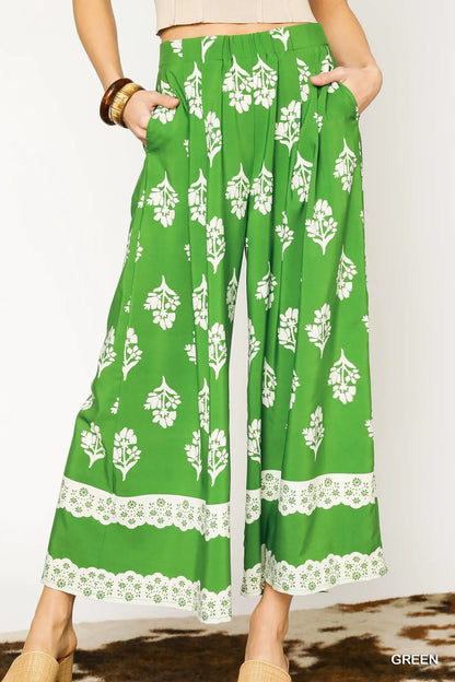 Green floral pleated wide-leg pants by Umgee, stylish and flowy with a comfortable fit, perfect for casual or dressy occasions.