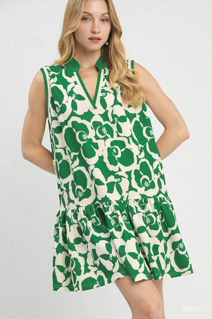 Green Umgee floral sleeveless tiered dress with a relaxed fit, featuring a tiered skirt and delicate floral pattern.
