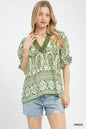 Green Umgee two-tone border print top with long sleeves and relaxed fit, displayed on a plain background.