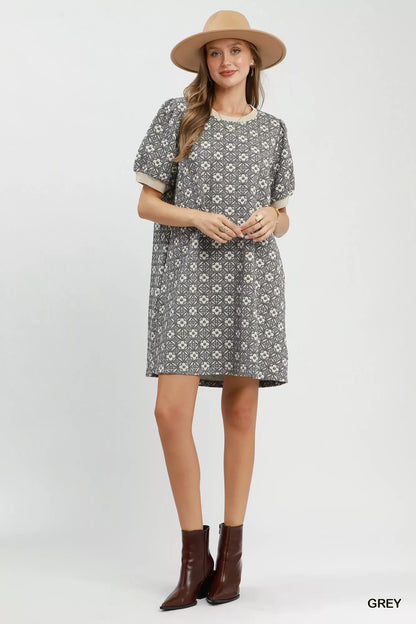 Grey Umgee floral textured puff sleeve mini dress with a fitted bodice and short puffed sleeves, shown on a model.