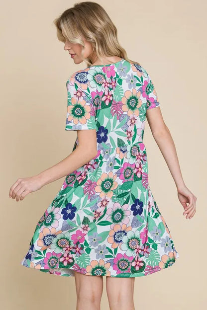 Trendsi BOMBOM ruched floral V-neck short sleeve dress with a feminine design and vibrant leaf print.