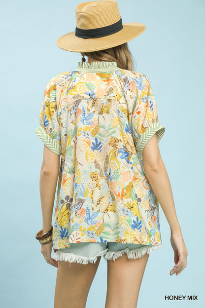 Umgee Mix Boho Printed V-Neck Top in honey color with a relaxed fit and bohemian floral print, short sleeves, and lightweight fabric.