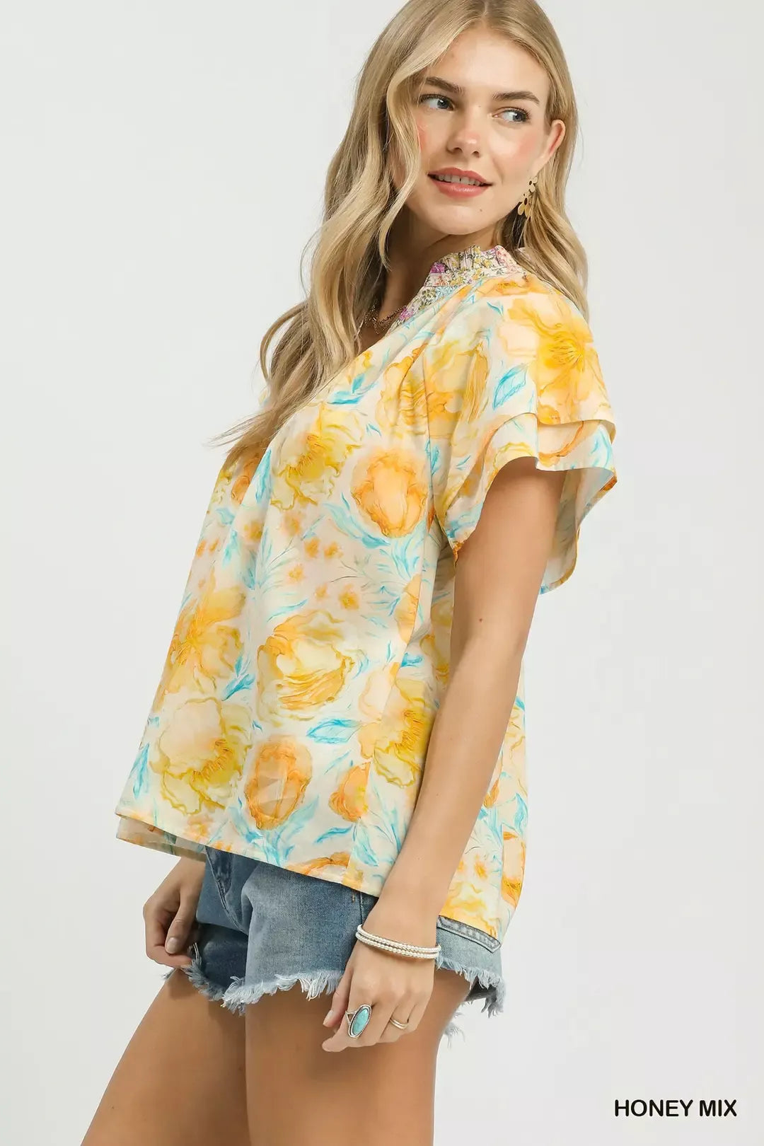 Umgee floral print blouse with crochet lace trim, featuring a mixed floral pattern and stylish design, perfect for casual wear.
