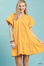 Umgee mini dress with flutter sleeves, tassel tie detail, and ruffle hem, styled in a casual, boho-inspired look