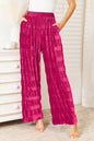 Hot pink velvet wide leg pants with high waist and tiered shirring from Trendsi, showcasing the stylish, flowing design.