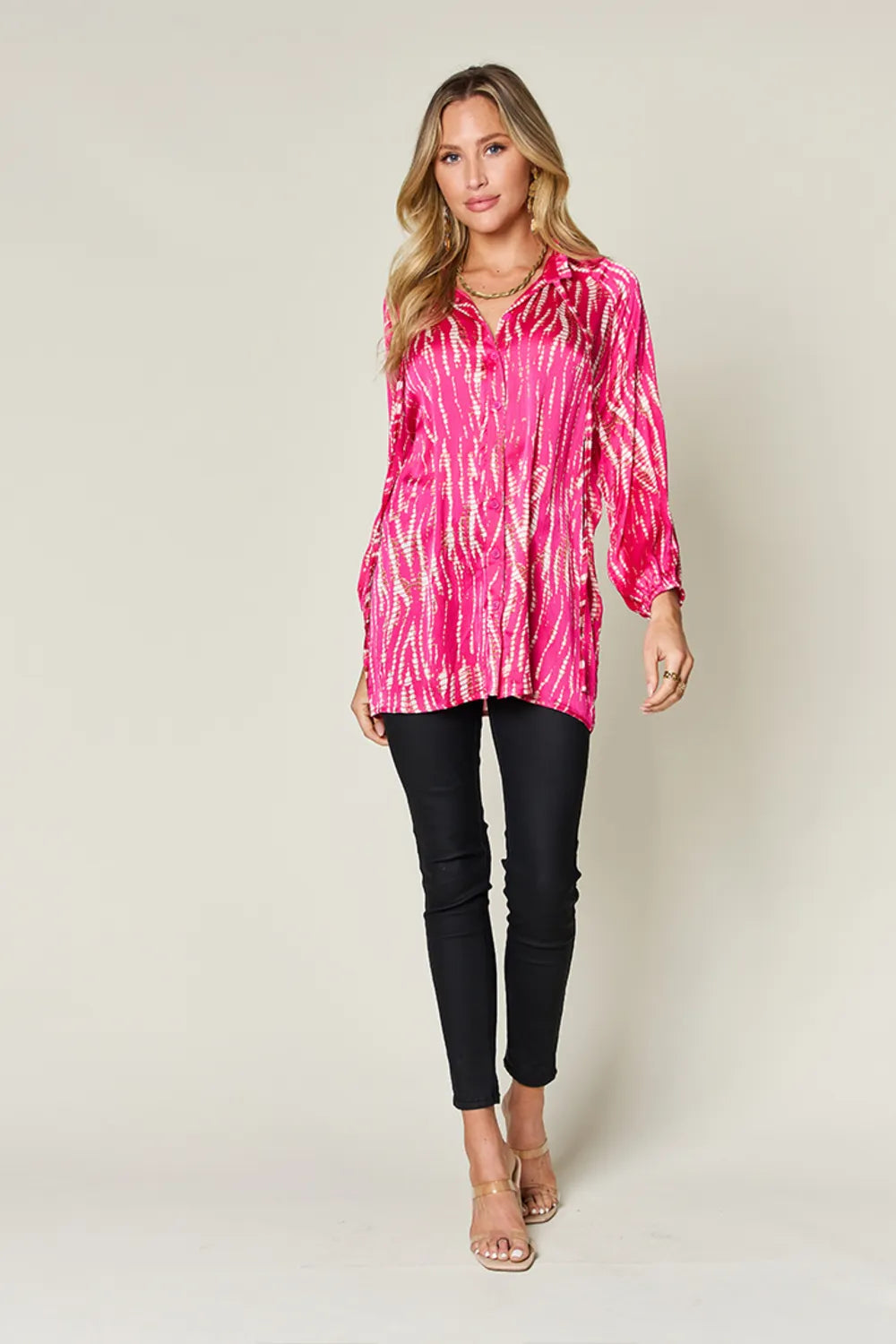 Bright pink Trendsi Double Take full-size printed long sleeve button-up shirt with bold floral pattern.