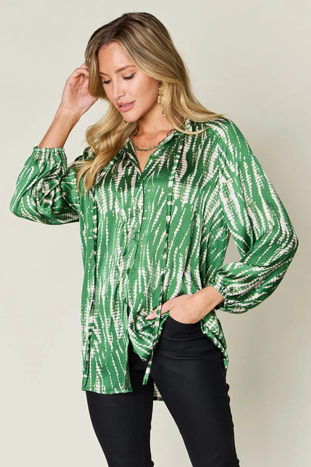Hot pink Trendsi Double Take full-size printed button-up long sleeve shirt hanging on a rack with a casual fit.