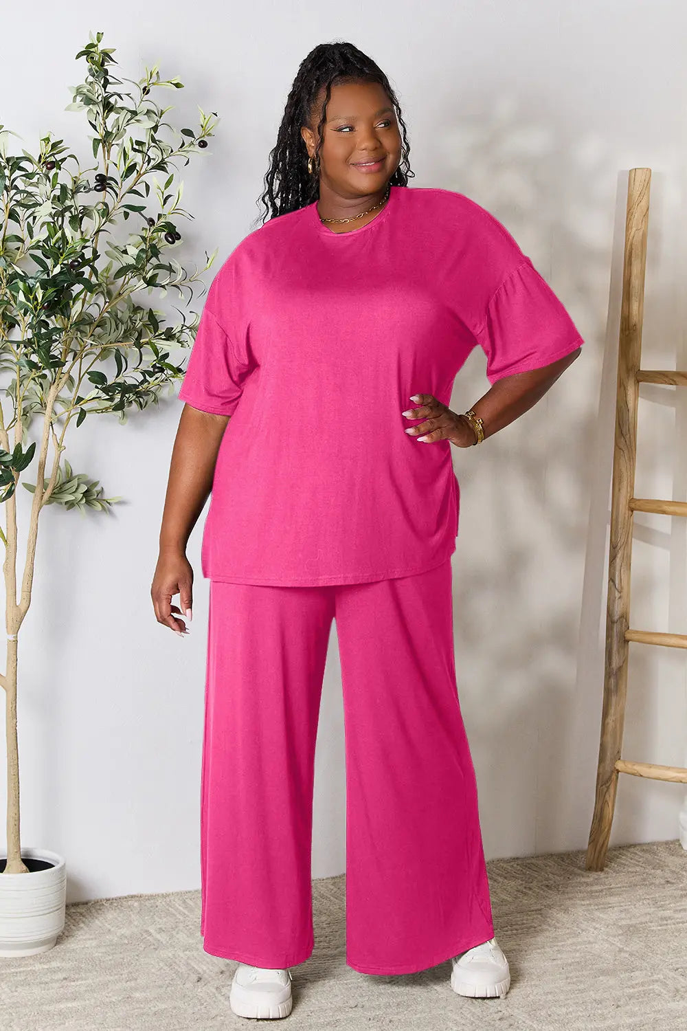 Hot pink double take full size round neck slit top and matching pants set by Trendsi, styled on a model.