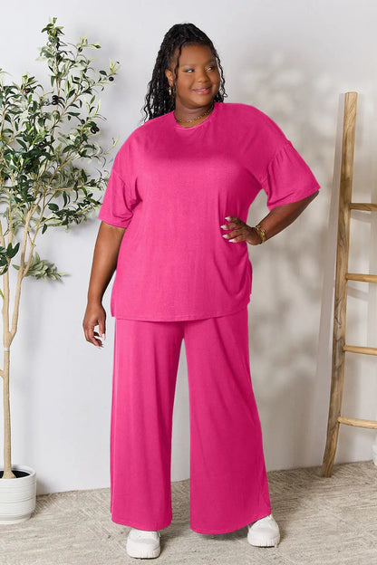 Hot pink double take full size round neck slit top and matching pants set by Trendsi, styled on a model.