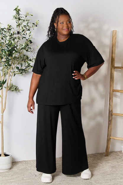Hot pink Trendsi Double Take full size round neck slit top and matching pants set displayed on a model.