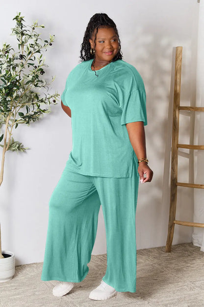 Hot pink double take full-size round neck slit top and pants set by Trendsi, featuring a stylish, coordinated outfit.