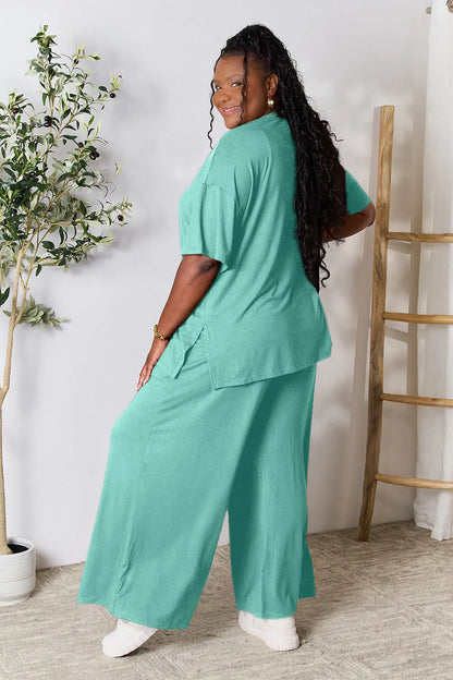 Hot pink double take full-size round neck slit top and matching pants set by Trendsi, stylish and comfortable women's outfit.