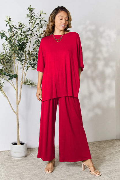 Hot pink double take full-size round neck slit top and matching pants set by Trendsi, stylish and comfortable women's clothing ensemble.