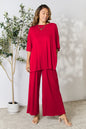 Hot pink double take full-size round neck slit top and matching pants set by Trendsi, stylish and comfortable women's clothing ensemble.
