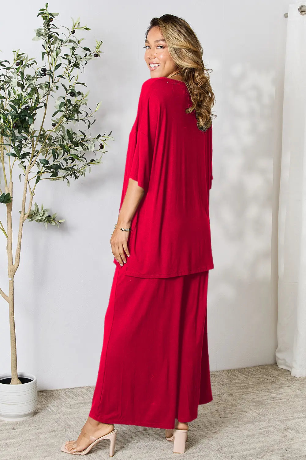 Hot pink Trendsi Double Take full-size round neck slit top and matching pants set, stylish and comfortable for casual wear.