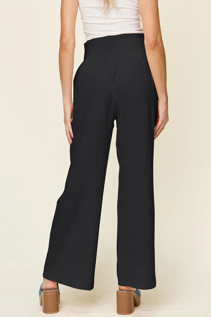 Hot pink wide-leg pants with textured fabric and smocked waist from Trendsi's Double Take collection, full size available.