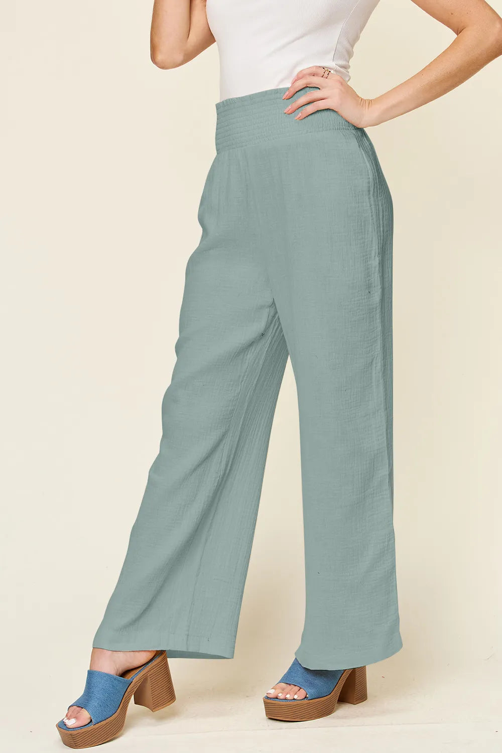 Hot pink double take full-size texture wide-leg pants with smocked waist by Trendsi, showcasing their flowy, relaxed fit.