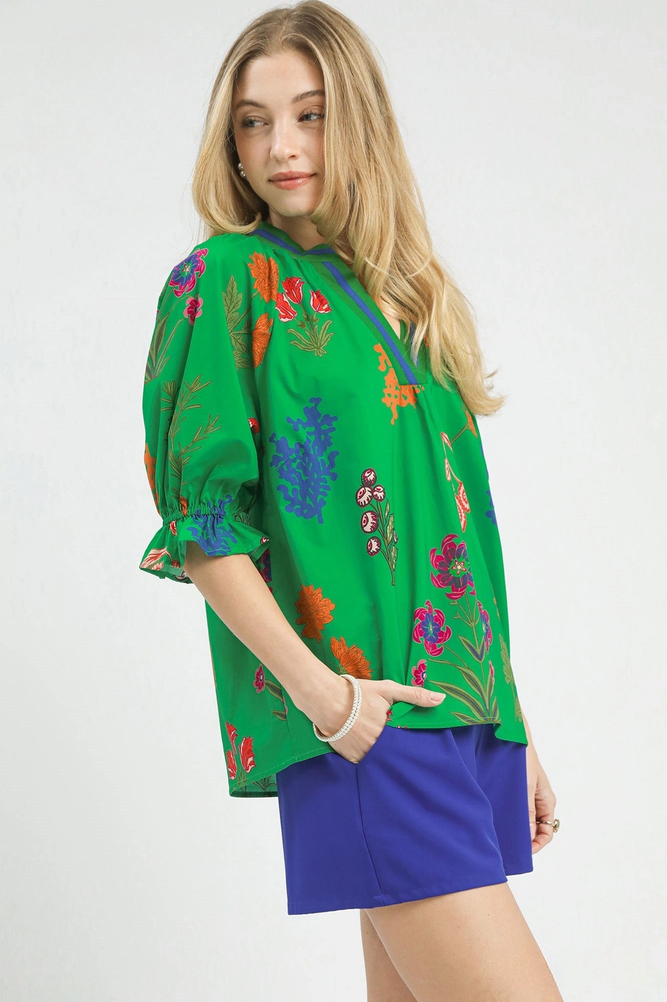 Island green floral Umgee top with split neckline and puff sleeves, featuring a stylish and feminine design.