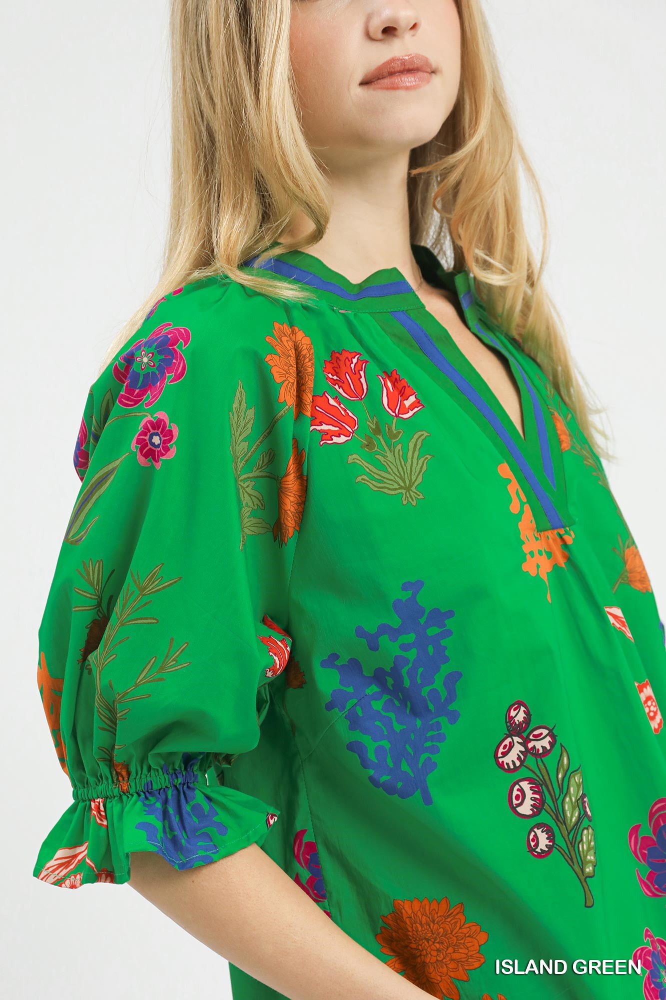 Trendsi Umgee floral split neck puff sleeve top in island green with a relaxed fit and feminine floral pattern.