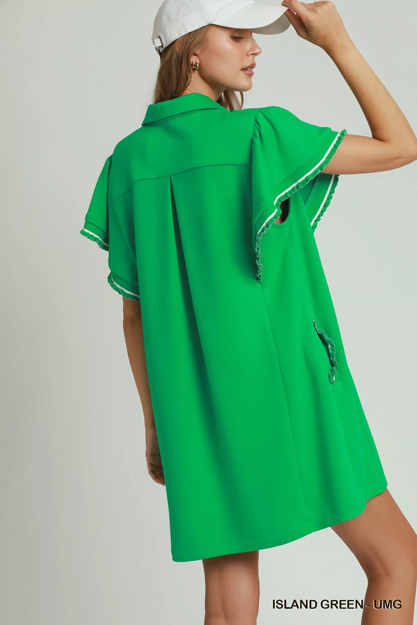 Island green Umgee mini dress with ruffle rib band, butterfly sleeves, half-zip, and pockets, styled for a casual look.