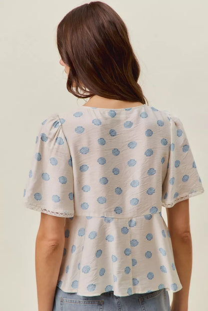 Trendsi Ivory and blue shell print tie-front blouse with flutter sleeves, stylish top for casual or dressy wear.