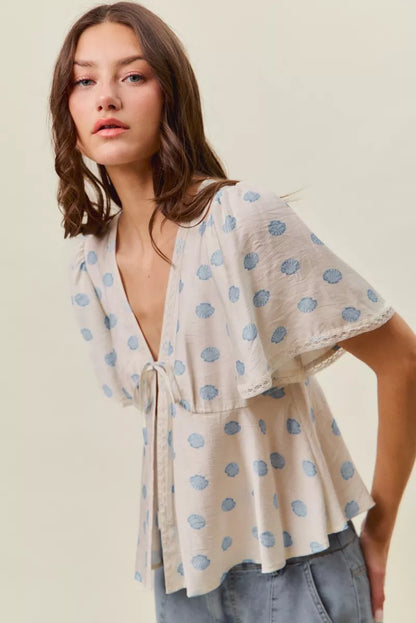Ivory and blue SO ME shell print blouse top with tie-front and flutter sleeves, by Trendsi.