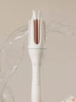 Trendsi automatic rotating ceramic curling iron in ivory with European plug, showcasing its ergonomic design and rotating barrel.