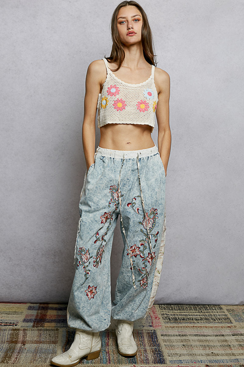 Ivory multi U-neck cropped crochet cami by Trendsi with floral embroidery detail, featuring a fitted U-neck design and stylish crochet texture.