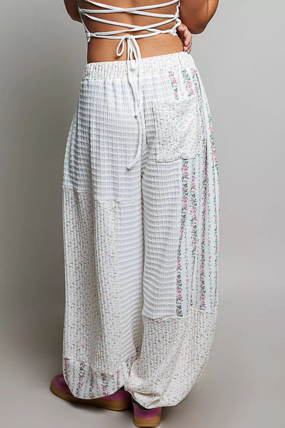 Ivory and multi-colored patchwork knit wide-leg pants from Trendsi, featuring a relaxed fit and mixed knit design.