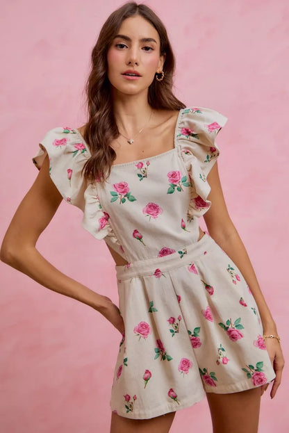 Trendsi ivory pink floral print denim romper with cut-out waist and ruffled details, perfect for casual summer wear.