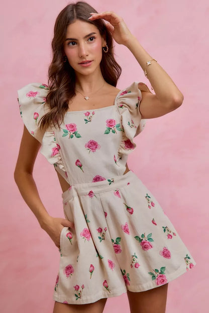 Ivory pink floral print denim romper with cut-out waist and ruffled details, trendy and stylish by Trendsi.