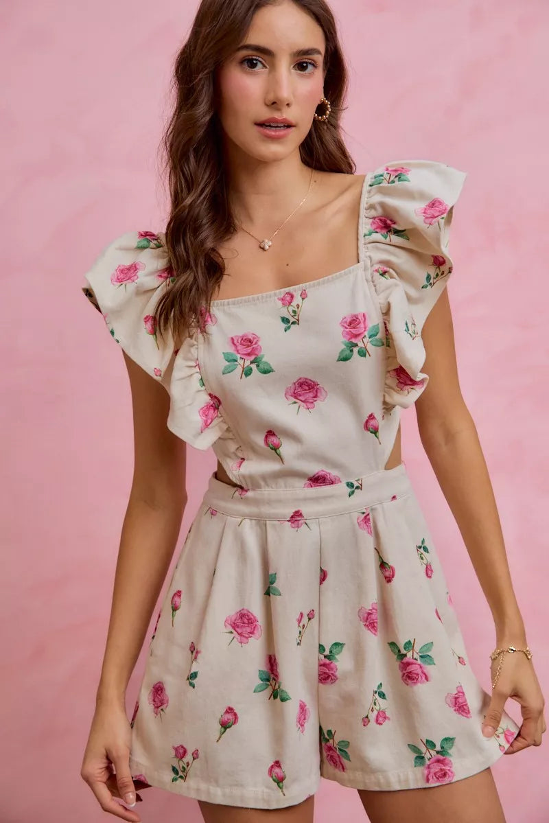 Ivory and pink floral print denim romper with ruffled details, cut-out waist, and trendy design by Trendsi.