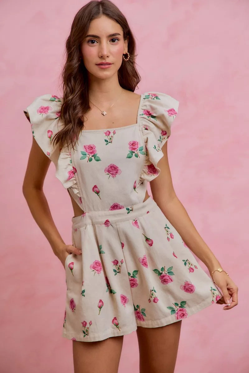 Ivory pink floral print denim romper with cut-out waist and ruffled details, styled by Trendsi.