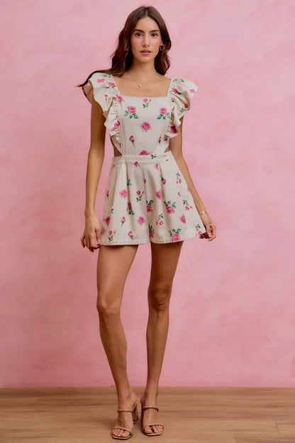 Ivory pink floral print denim romper with cut-out waist and ruffled details, designed by Trendsi.