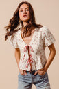 Ivory and red check ditsy floral print gauze tie-front blouse by Trendsi, featuring lightweight fabric and feminine design.